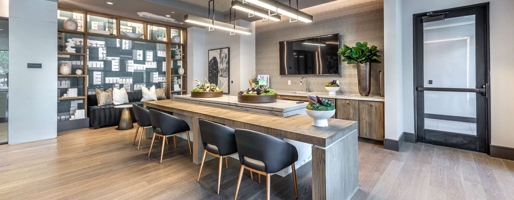 open kitchen with ample lighting and island seating in resident lounge