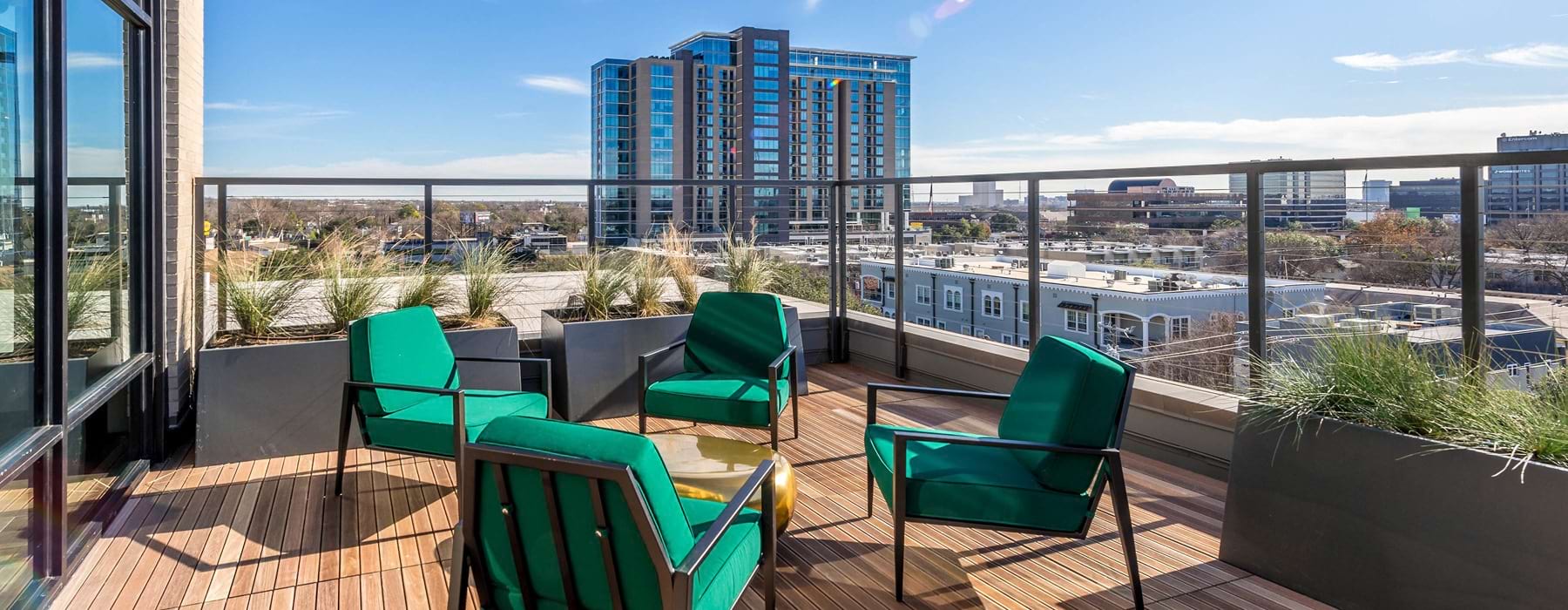 social seating areas on rooftop terrace with city views